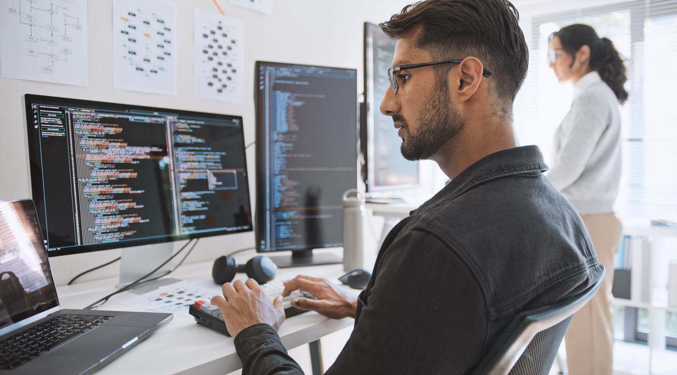 Professional software developers working together in a modern office